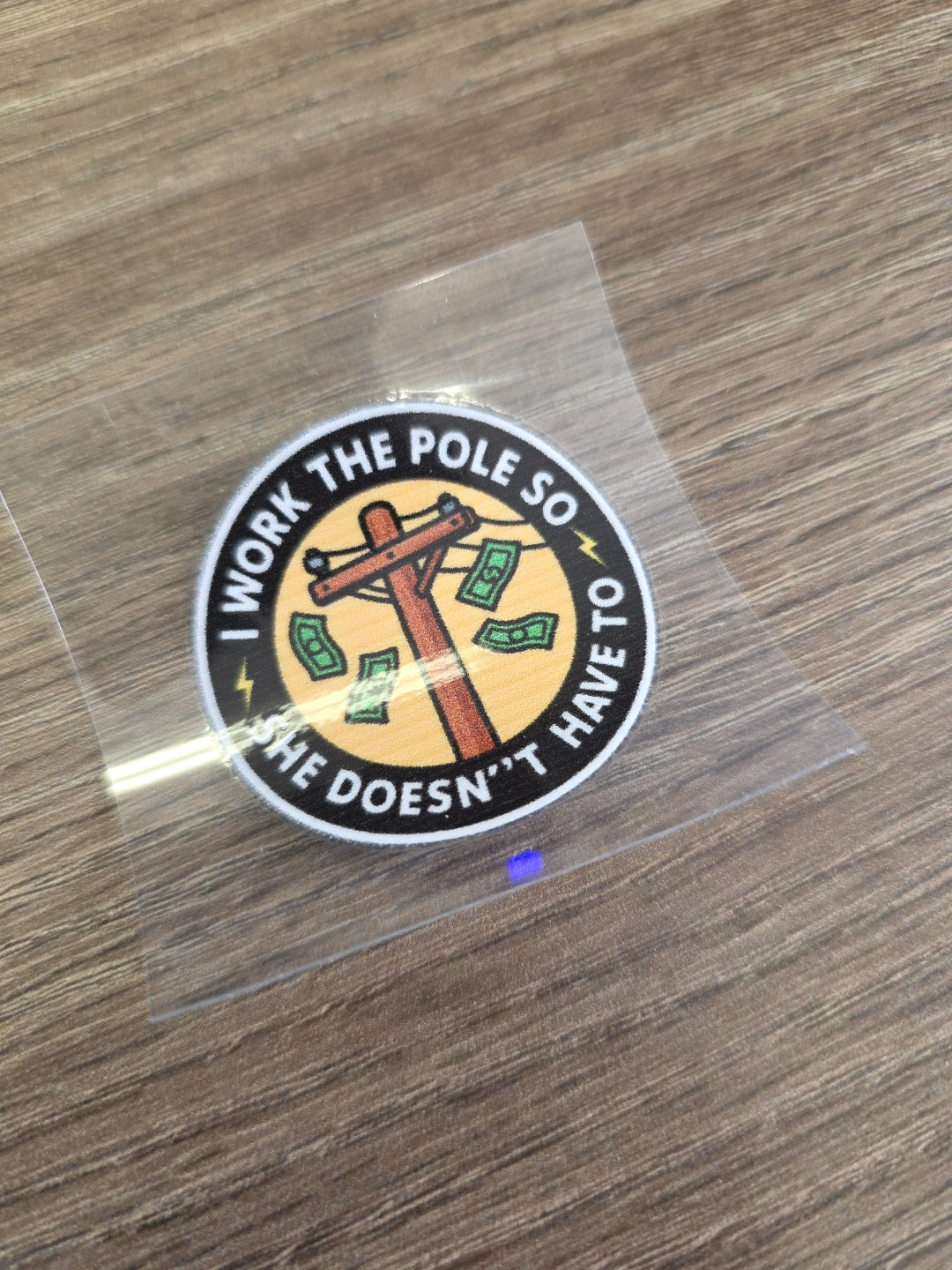 “I Work the Pole So She Doesn’t Have To” Decal – Funny Lineman Hard Hat Sticker | UV DTF