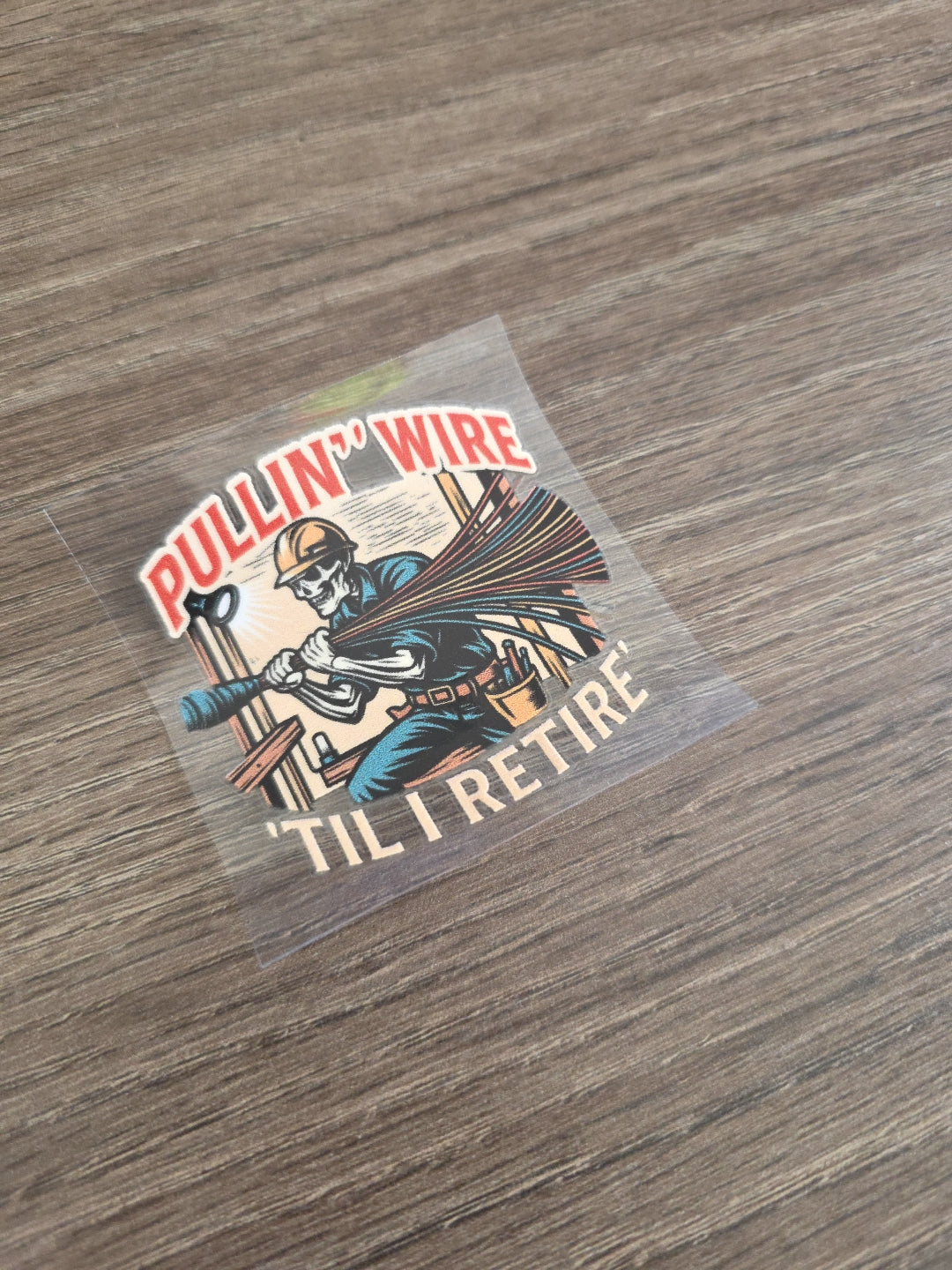 Pullin’ Wire ’Til I Retire – Electrician UV DTF Hard Hat Decal